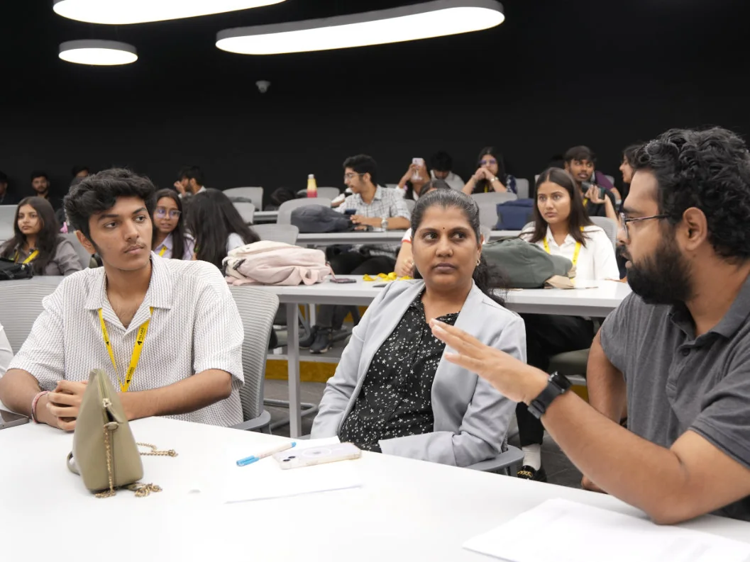 A judge gestures while questioning a student team at Polaris Demo Day